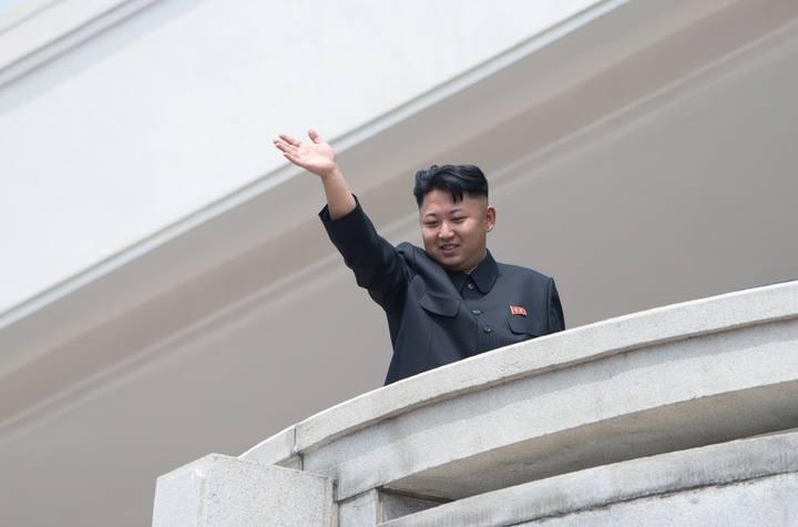 El líder norcoreano Kim Jong-un saluda a los asistentes durante el desfile.